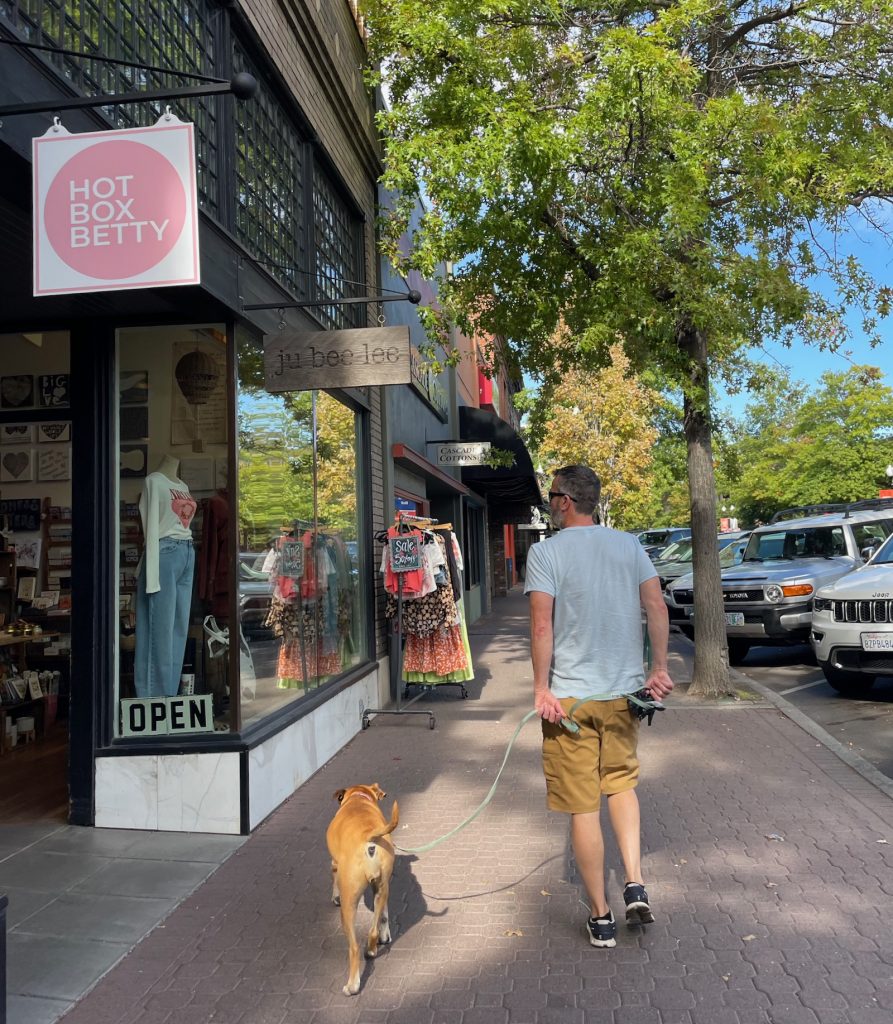 walking past shops in downtown Bend