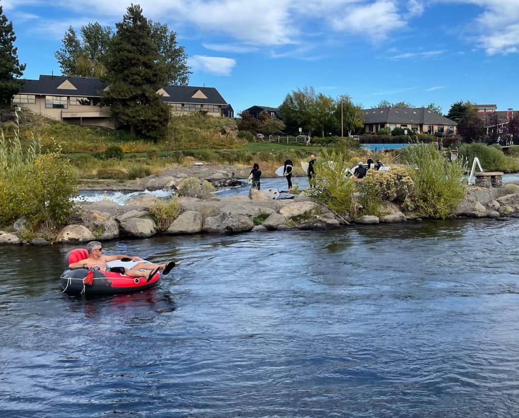 tuber and surfers on the Deschutes