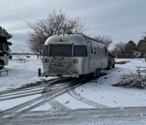the Airstream in the snow in Fort Stockton